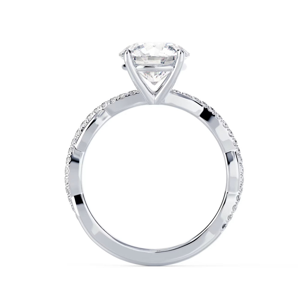 Close-up of a round cut lab grown diamond infinity pave engagement ring highlighting flowing infinity-inspired band design