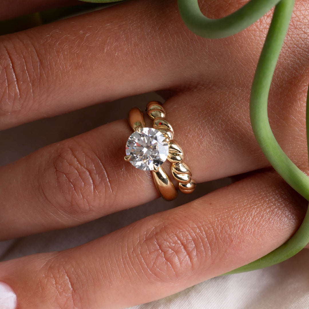 Detailed view of a round lab grown diamond solitaire engagement ring showing clean minimal design and sparkle