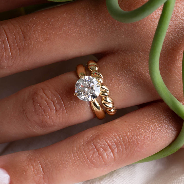Detailed view of a round lab grown diamond solitaire engagement ring showing clean minimal design and sparkle