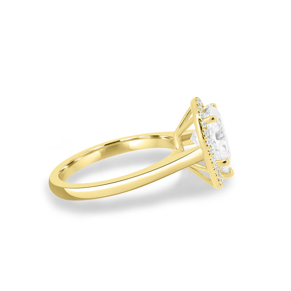 Side profile of round lab diamond halo pavé engagement ring showing delicate pavé shank and elevated center stone