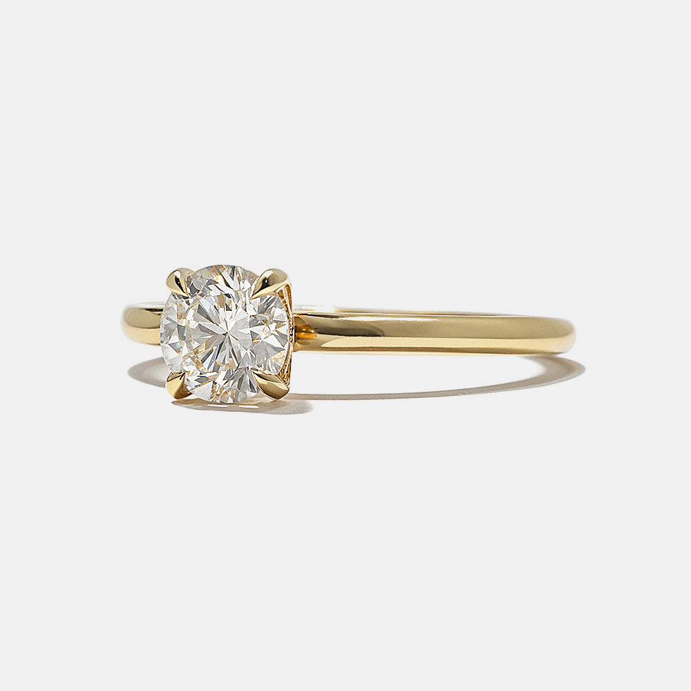 Close-up of round lab grown diamond solitaire engagement ring showing hidden halo detail beneath center stone
