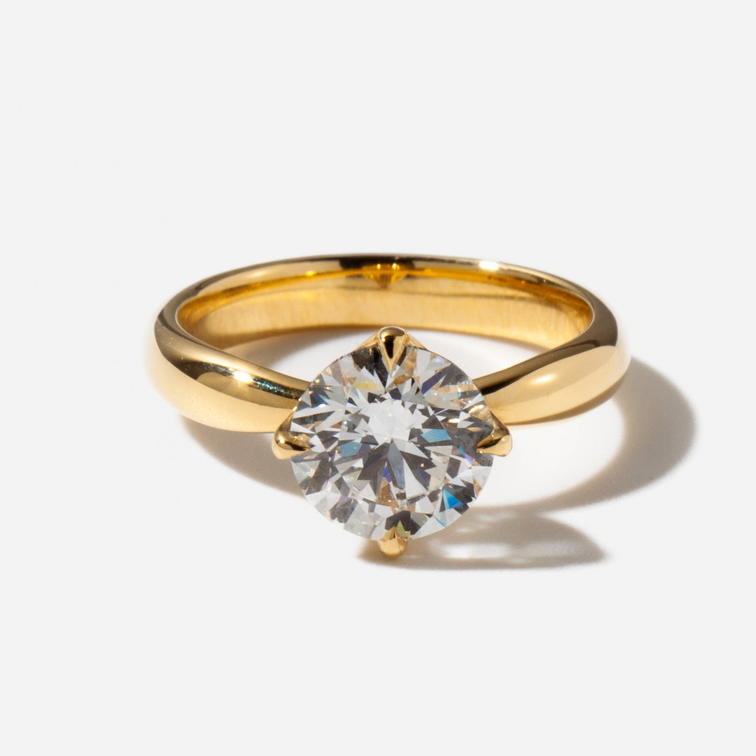 Close-up of a round lab grown diamond solitaire engagement ring highlighting exceptional fire and brilliance