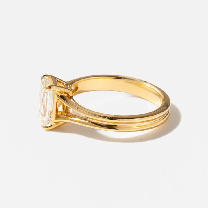 Side profile of a split shank lab diamond solitaire ring highlighting the elevated emerald cut center stone