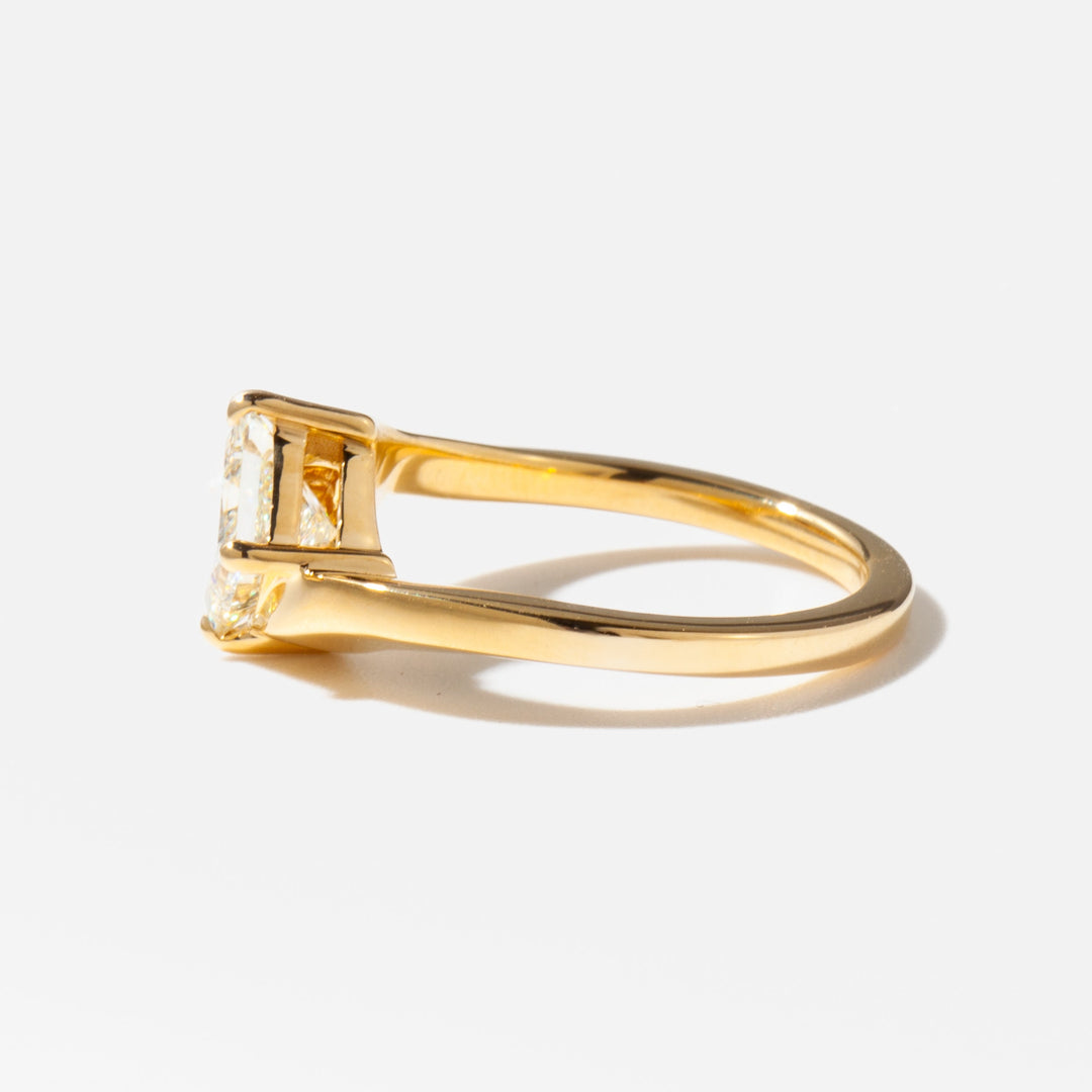 Side profile of a 1 carat princess lab diamond solitaire engagement ring with a distinctive modern setting design
