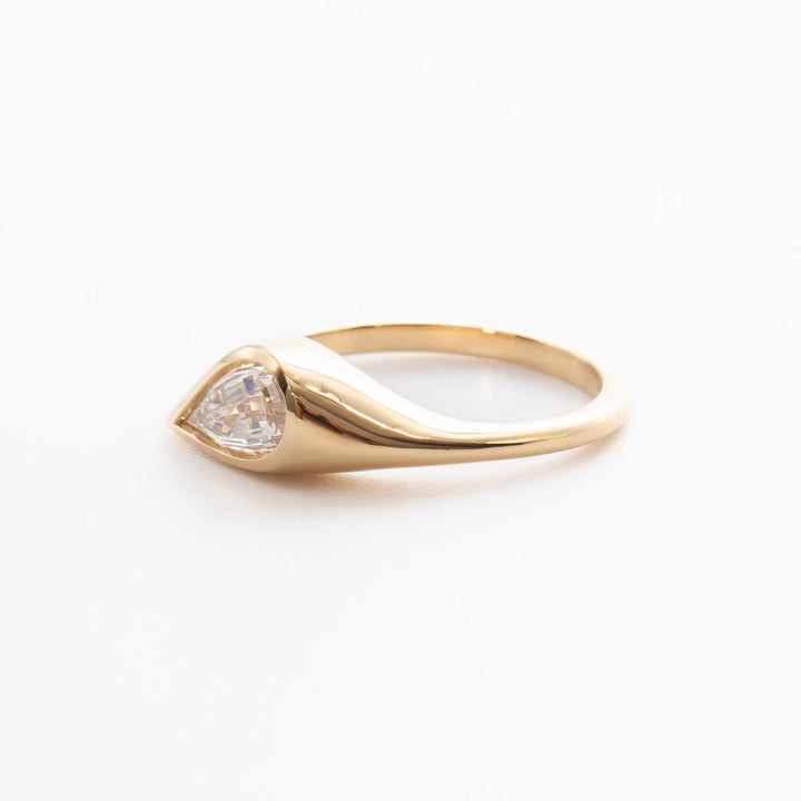 Vintage style pear cut lab grown diamond engagement ring featuring bezel setting and elegant antique proportions