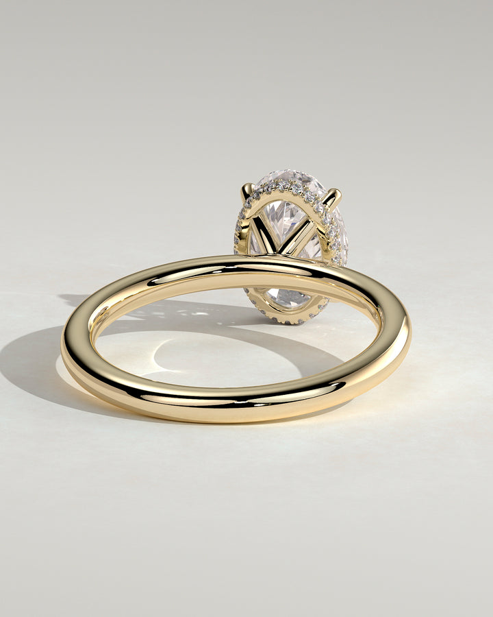 gold oval engagement ring hidden halo with band