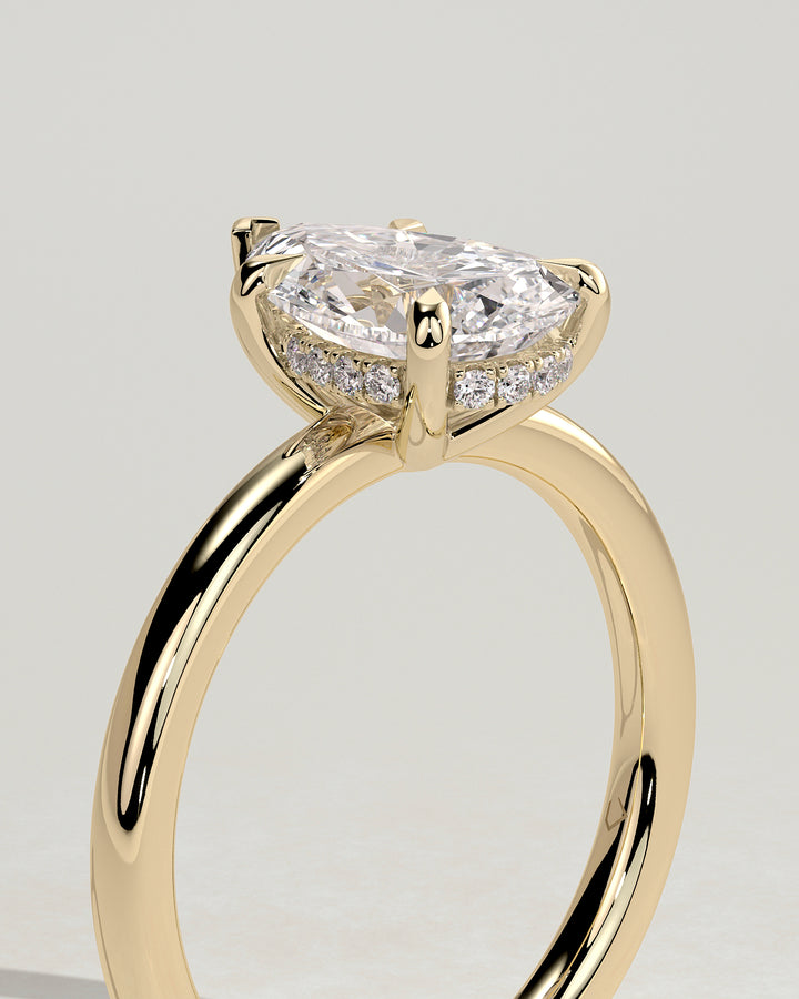 gold pear hidden halo engagement ring