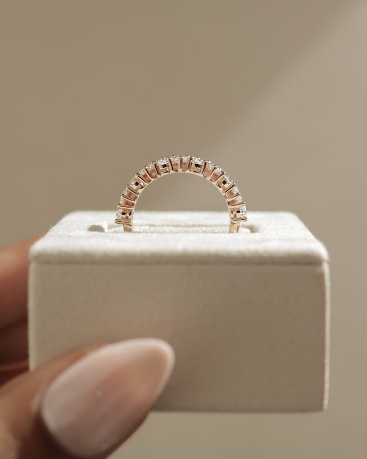 pear engagement ring and wedding band stack with diamonds