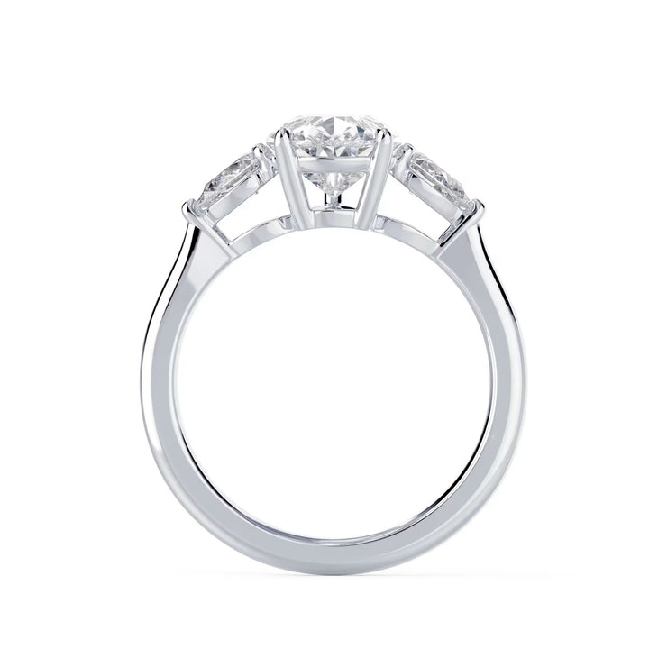 Close-up of a pear cut lab grown diamond three stone engagement ring highlighting sparkle and elegant proportions