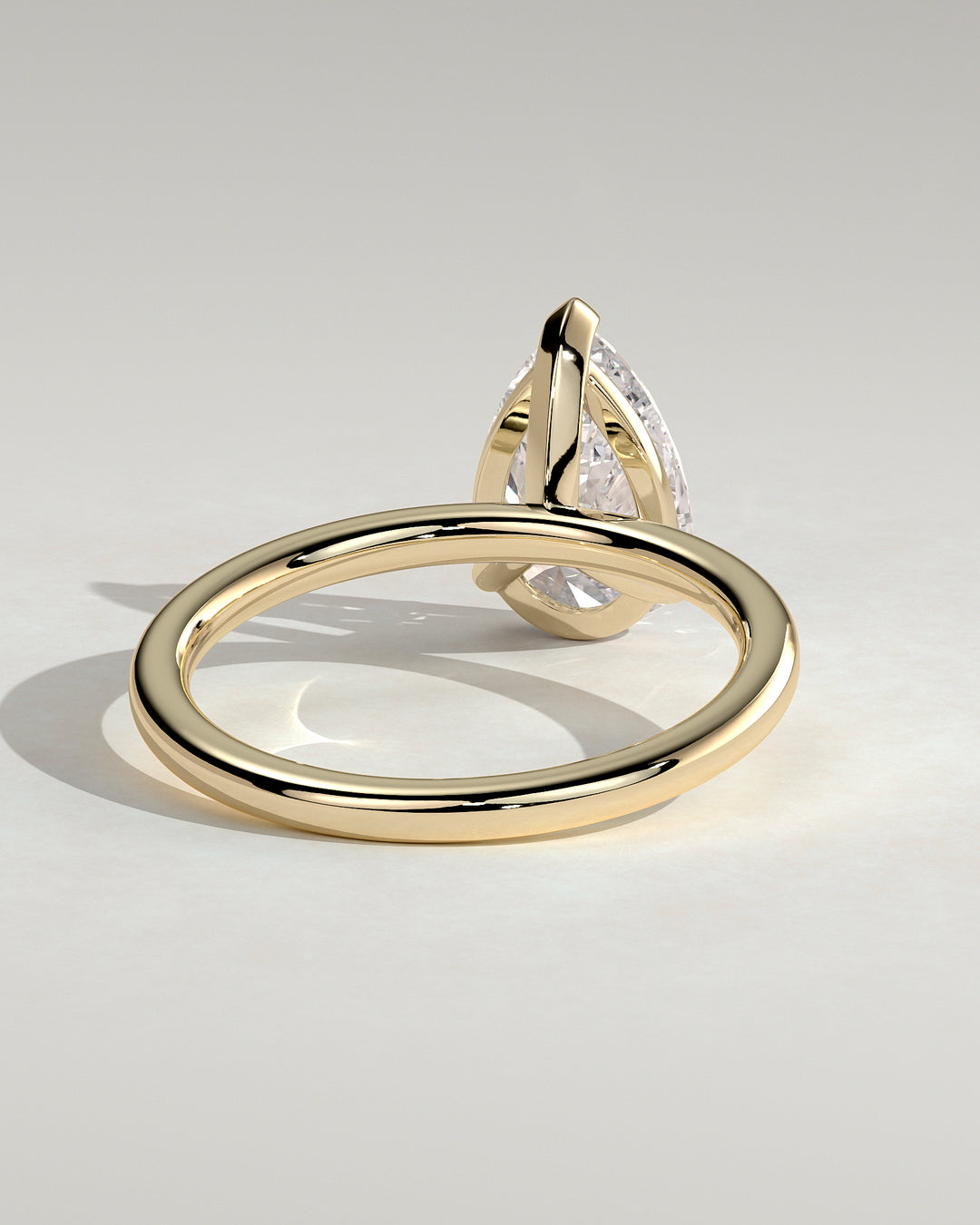 solitaire pear engagement ring with gold band